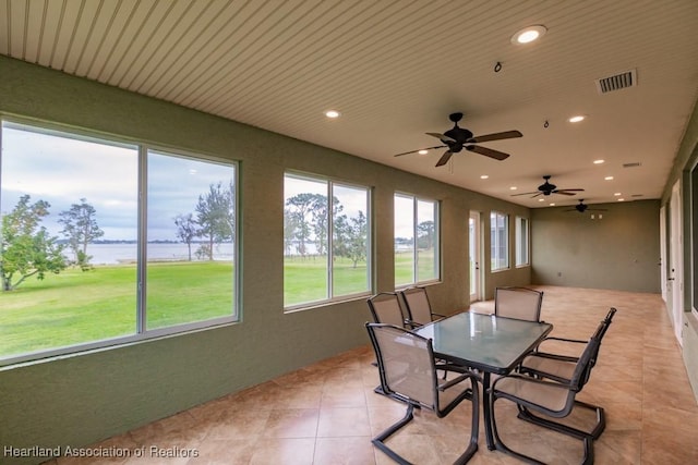 sunroom featuring ceiling fan and a healthy amount of sunlight