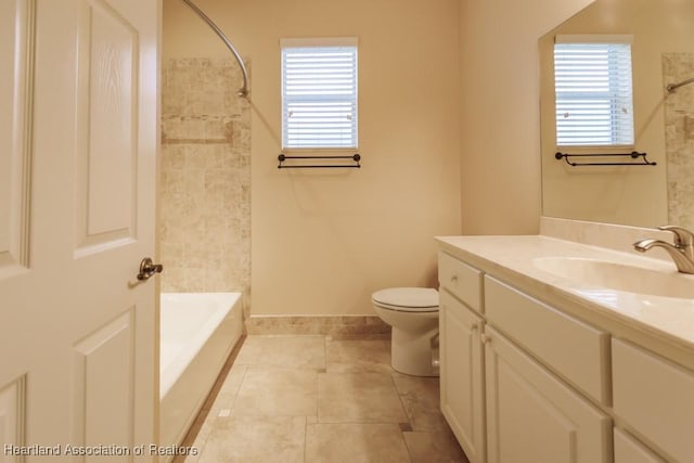 full bathroom featuring tile patterned flooring, vanity, tiled shower / bath combo, and toilet