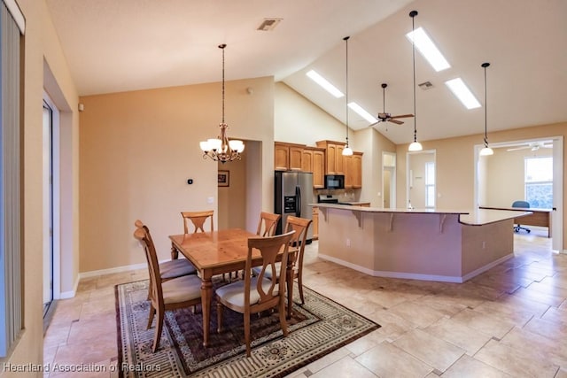 dining room with ceiling fan with notable chandelier and high vaulted ceiling