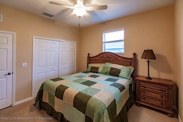 carpeted bedroom featuring ceiling fan and a closet