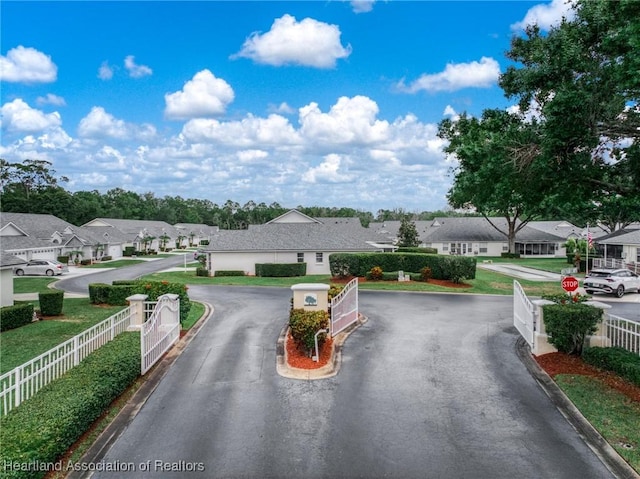2036 Ashley Oaks Cir, Sebring, FL 33870 - view of asphalt road with a residential view, traffic signs, and curbs