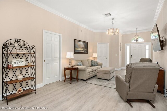 2036 Ashley Oaks Cir, Sebring, FL 33870 - living room with a chandelier, crown molding, light wood-style floors, and baseboards