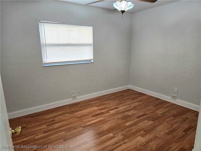 empty room featuring wood-type flooring and ceiling fan