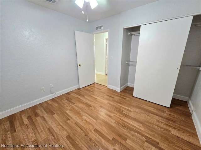 unfurnished bedroom featuring a closet and light wood-type flooring