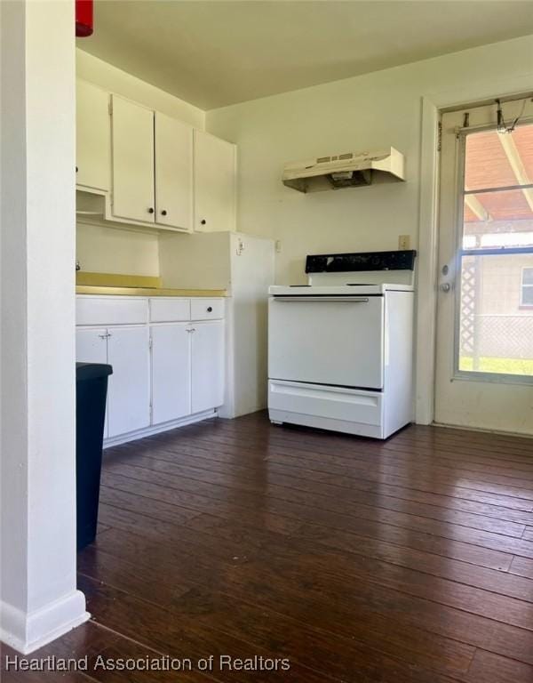 kitchen featuring white range with electric stovetop, dark hardwood / wood-style flooring, white cabinets, and extractor fan