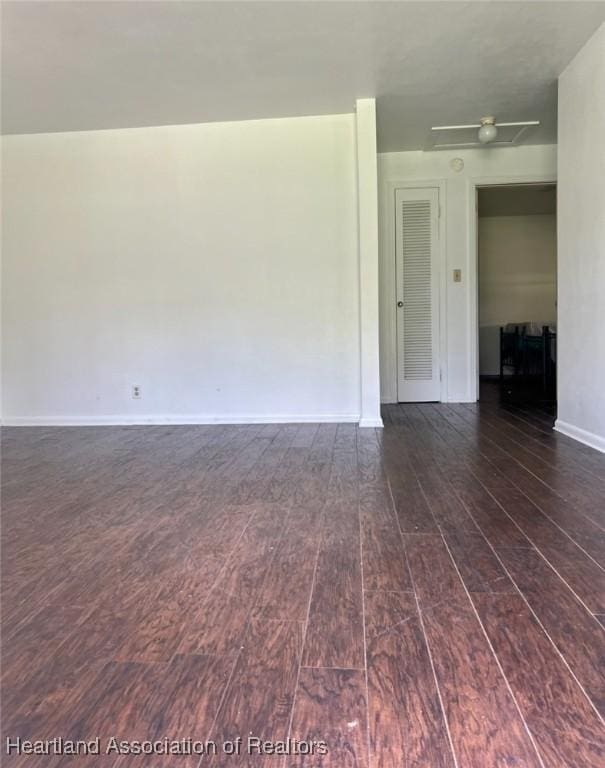 unfurnished room with dark hardwood / wood-style flooring