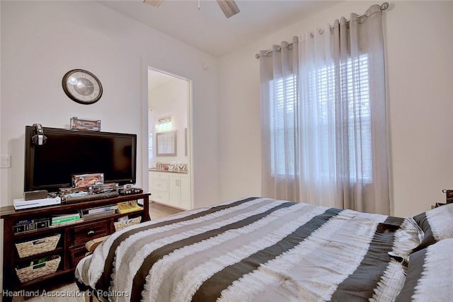 bedroom with ensuite bathroom, ceiling fan, and hardwood / wood-style flooring