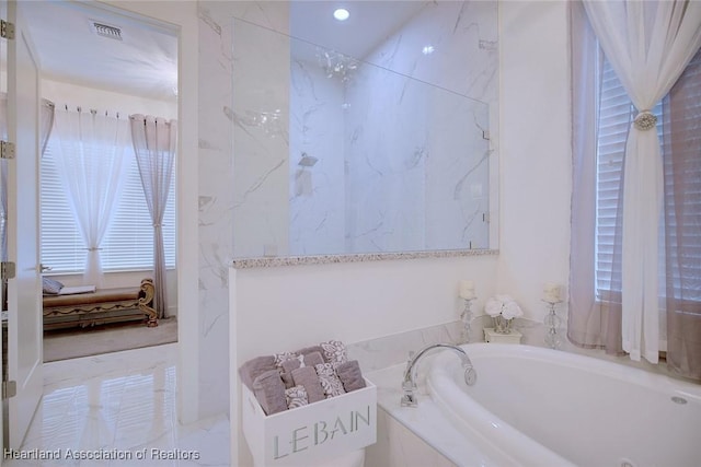 bathroom featuring tiled bath