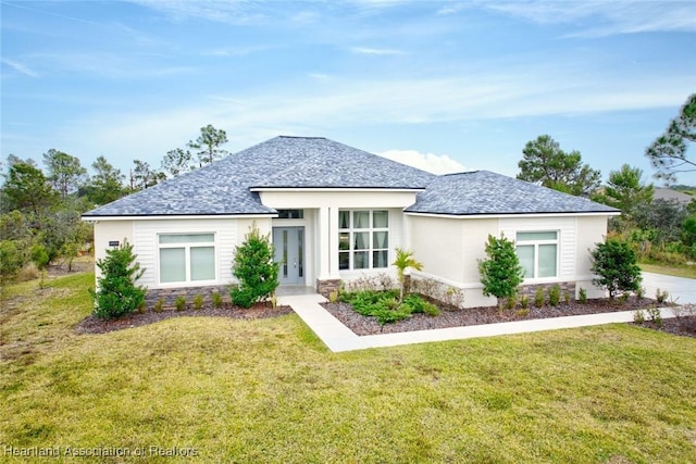 view of front of house featuring a front lawn and french doors