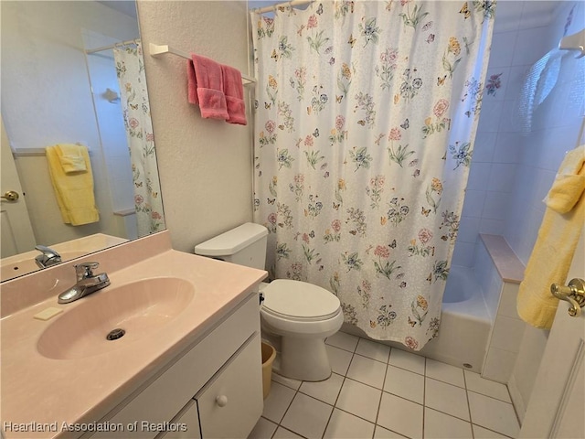 full bathroom featuring tile patterned floors, vanity, toilet, and shower / tub combo