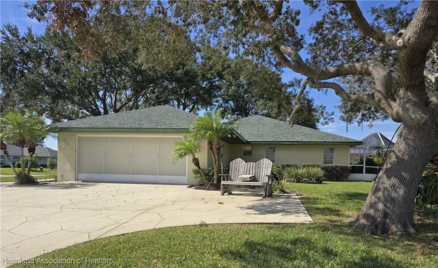 ranch-style house featuring a garage and a front lawn