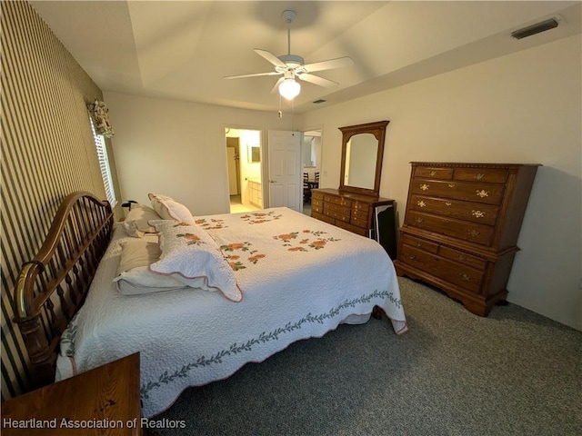 bedroom with carpet flooring, ensuite bathroom, and ceiling fan