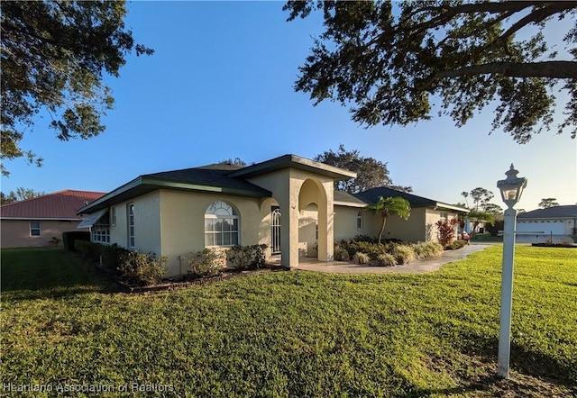 ranch-style home with a front lawn