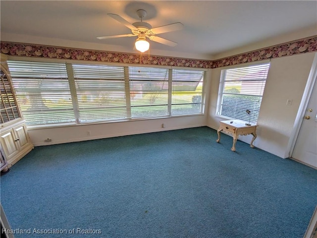 unfurnished sunroom with ceiling fan