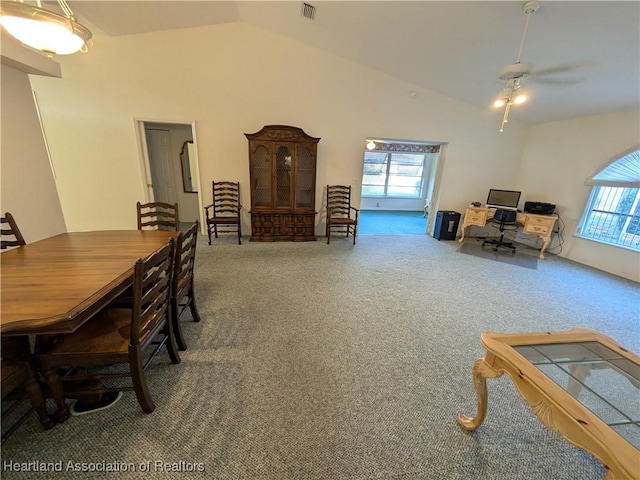 carpeted dining space with a wealth of natural light, ceiling fan, and lofted ceiling