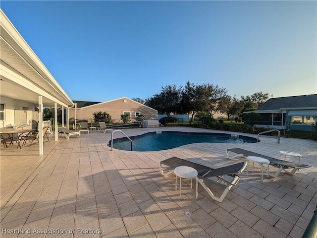 view of pool featuring a patio