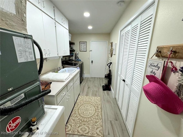 325 Anderson St NE, Lake Placid, FL 33852 - kitchen featuring white cabinetry, washer / dryer, and light wood-type flooring