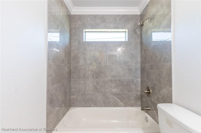 bathroom with toilet, tiled shower / bath, and ornamental molding