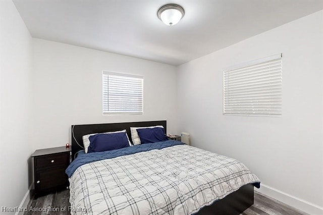 bedroom with dark wood-type flooring