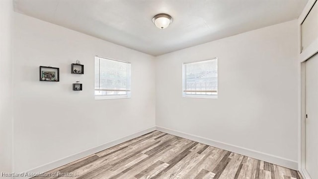 empty room with light hardwood / wood-style floors