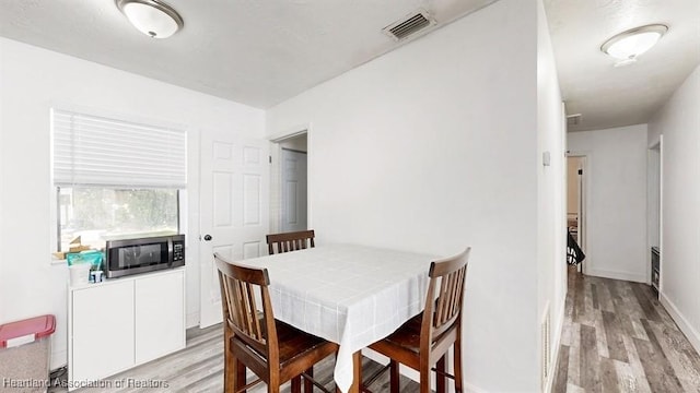 dining room with light hardwood / wood-style flooring