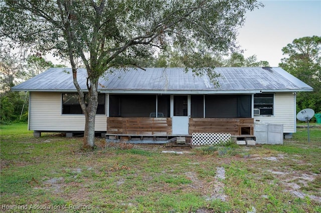 back of house featuring a sunroom