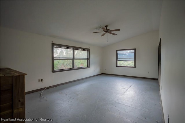 unfurnished room with vaulted ceiling, a wealth of natural light, and ceiling fan