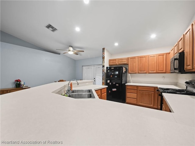 kitchen featuring black appliances, ceiling fan, and sink