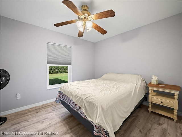 bedroom featuring hardwood / wood-style floors and ceiling fan