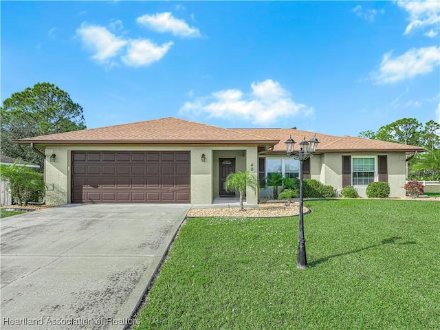 ranch-style house featuring a garage and a front lawn