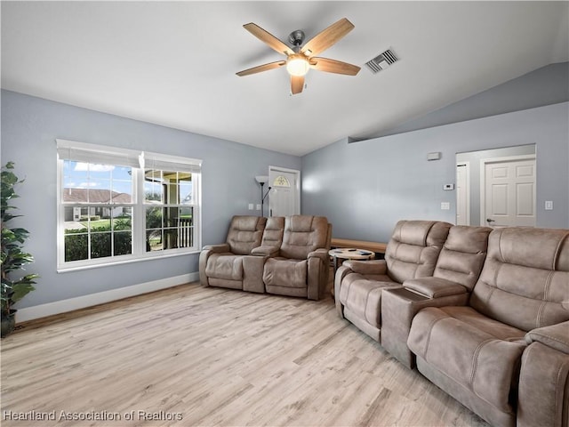 living room featuring ceiling fan, lofted ceiling, and light hardwood / wood-style flooring