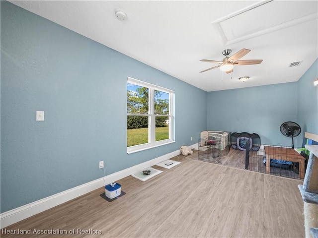 interior space with hardwood / wood-style flooring and ceiling fan