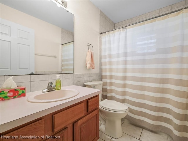 bathroom with backsplash, tile patterned floors, vanity, tile walls, and toilet