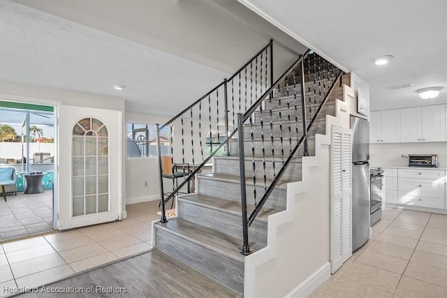 staircase featuring tile patterned flooring