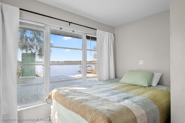 bedroom featuring a water view