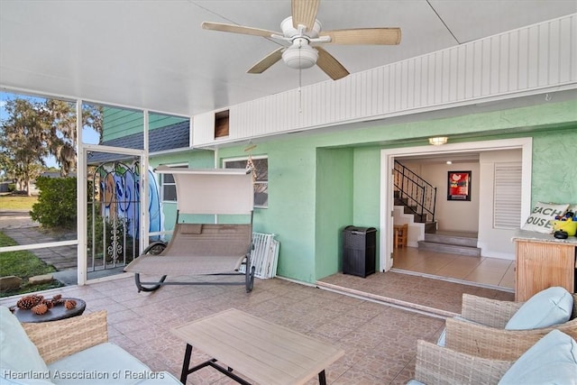 sunroom with ceiling fan