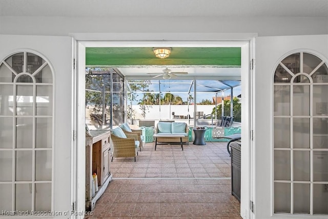 unfurnished sunroom with ceiling fan