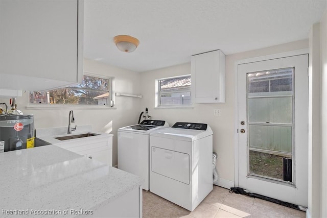 laundry room with separate washer and dryer, sink, water heater, and light tile patterned floors