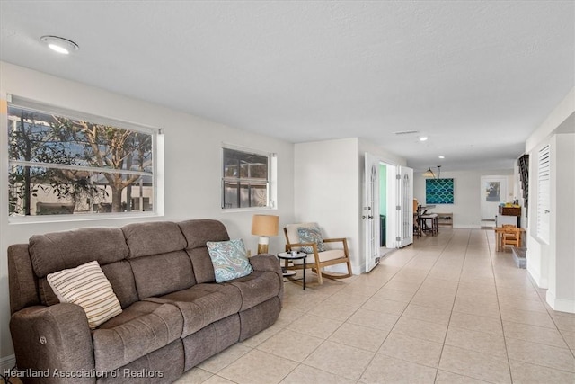 living room with light tile patterned floors and a textured ceiling