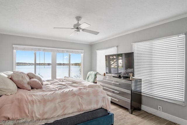 bedroom featuring multiple windows, crown molding, a textured ceiling, and ceiling fan