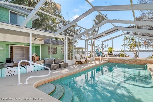 view of pool with ceiling fan, a lanai, and a patio area