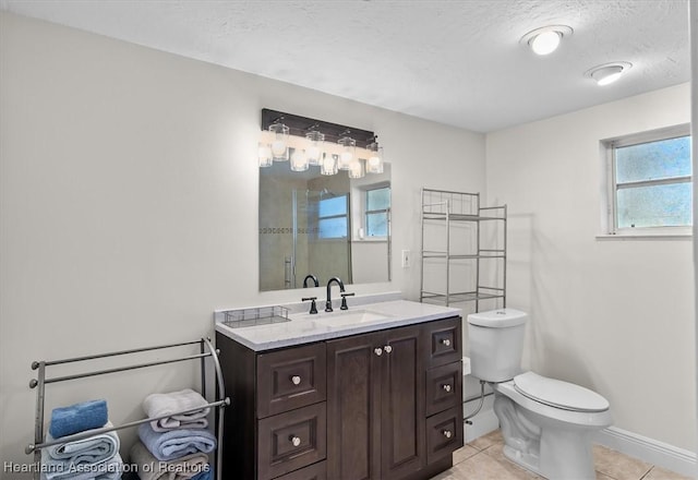 bathroom with a shower with door, tile patterned flooring, vanity, a textured ceiling, and toilet