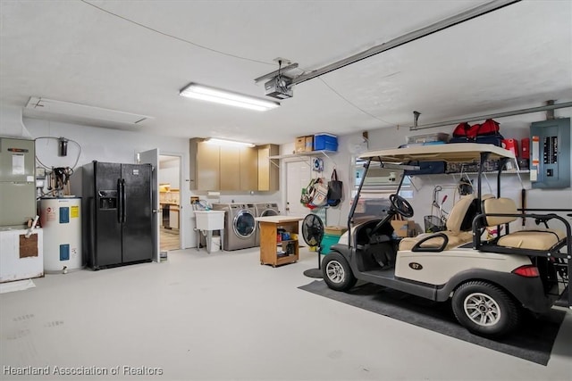 garage with black fridge, water heater, washing machine and clothes dryer, electric panel, and a garage door opener