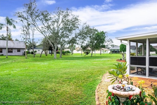 view of yard with a sunroom