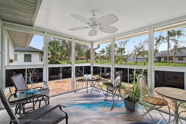 sunroom featuring ceiling fan