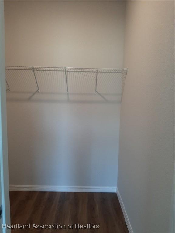 1508 Las Villas Blvd, Sebring, FL 33870 - spacious closet with dark wood-type flooring