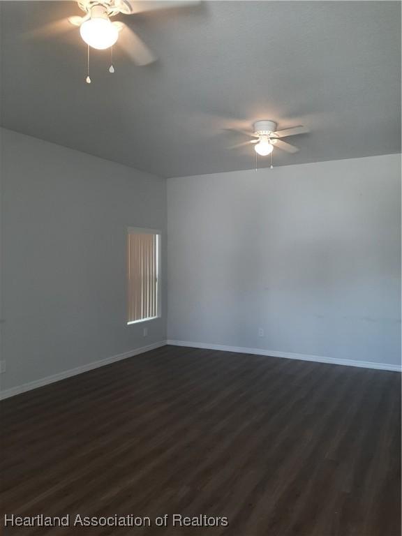 1508 Las Villas Blvd, Sebring, FL 33870 - spare room with ceiling fan, dark wood-type flooring, and baseboards