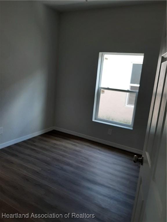 1508 Las Villas Blvd, Sebring, FL 33870 - empty room featuring dark wood finished floors and baseboards