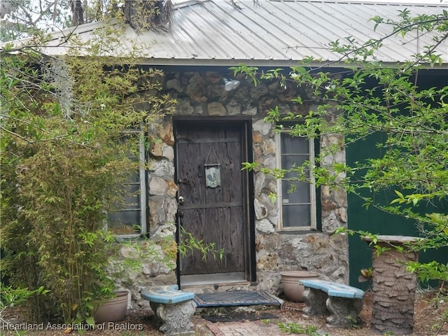 12115 S US Highway 41, Gibsonton, FL 33534 - property entrance featuring stone siding and a metal roof