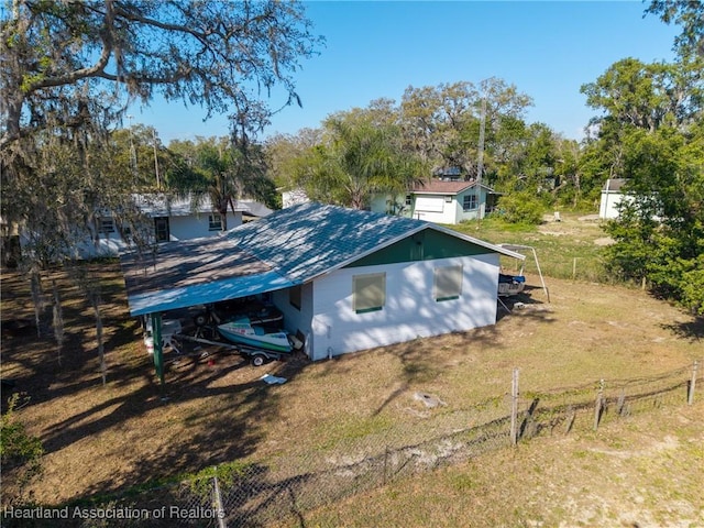 view of outbuilding featuring fence